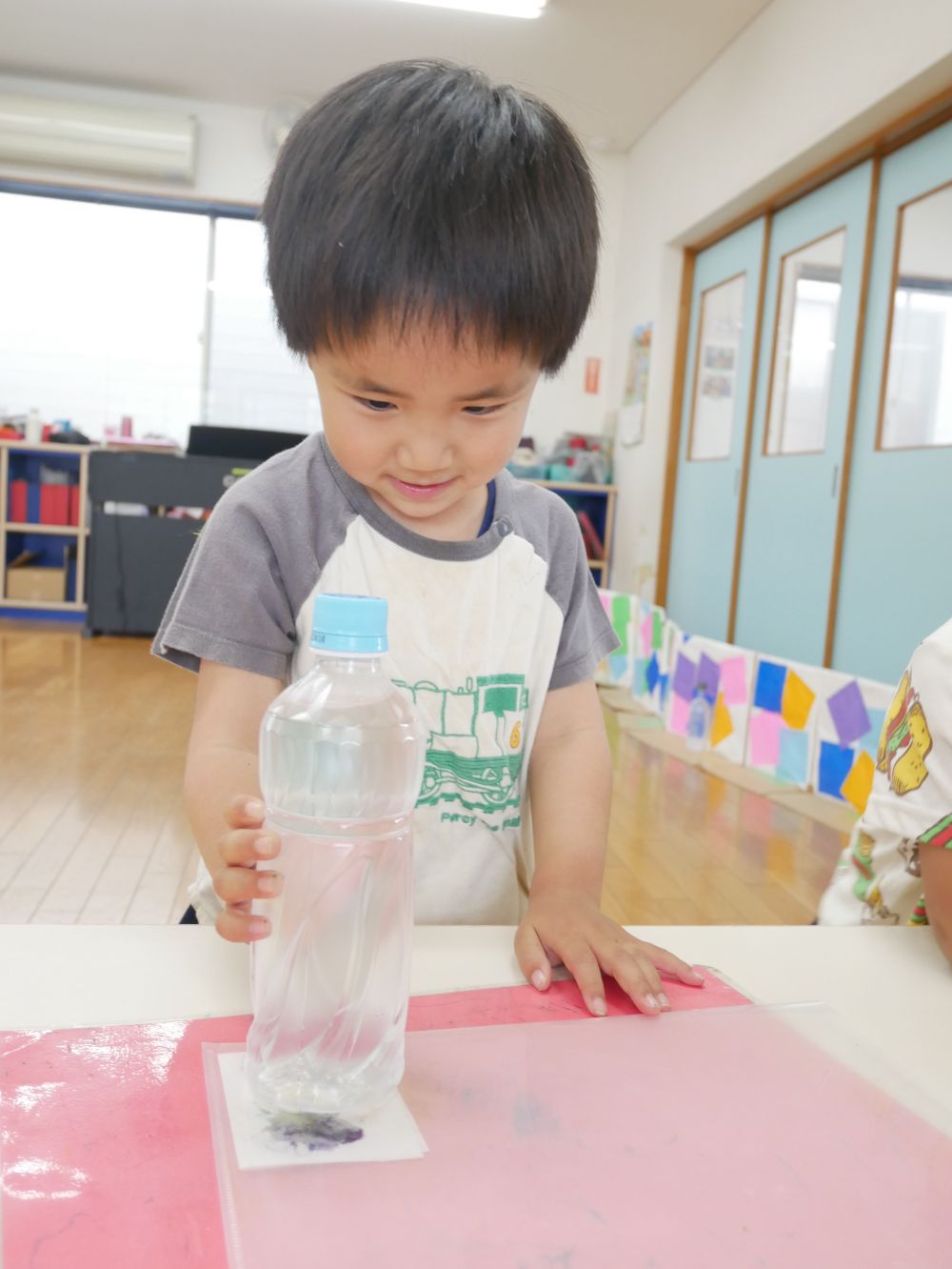 園に花を持ち帰ると・・・
『でも花が枯れるのが嫌・・・』
『可愛いのに花が小さくなる・・・』
綺麗な状態で花を残したい子どもたち
そこで保育教諭も一緒に考え花の染め絵をしてみることに♡
ペットボトルで叩いて・・・紙に色が移るかな？
段々と紙に花の色が移るのが見えてきて思わず口元が緩むIくん♡