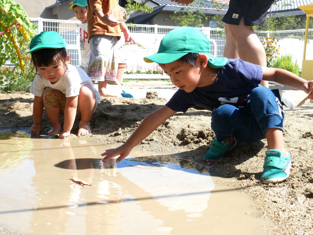 『この水たまりは川みたいじゃね』
『船を浮かべてみよう？』
『あっ！浮かんでるよ！いい感じ』
友達と一緒に喜びを感じながら・・・
励まされながら遊ぶ姿がみられました