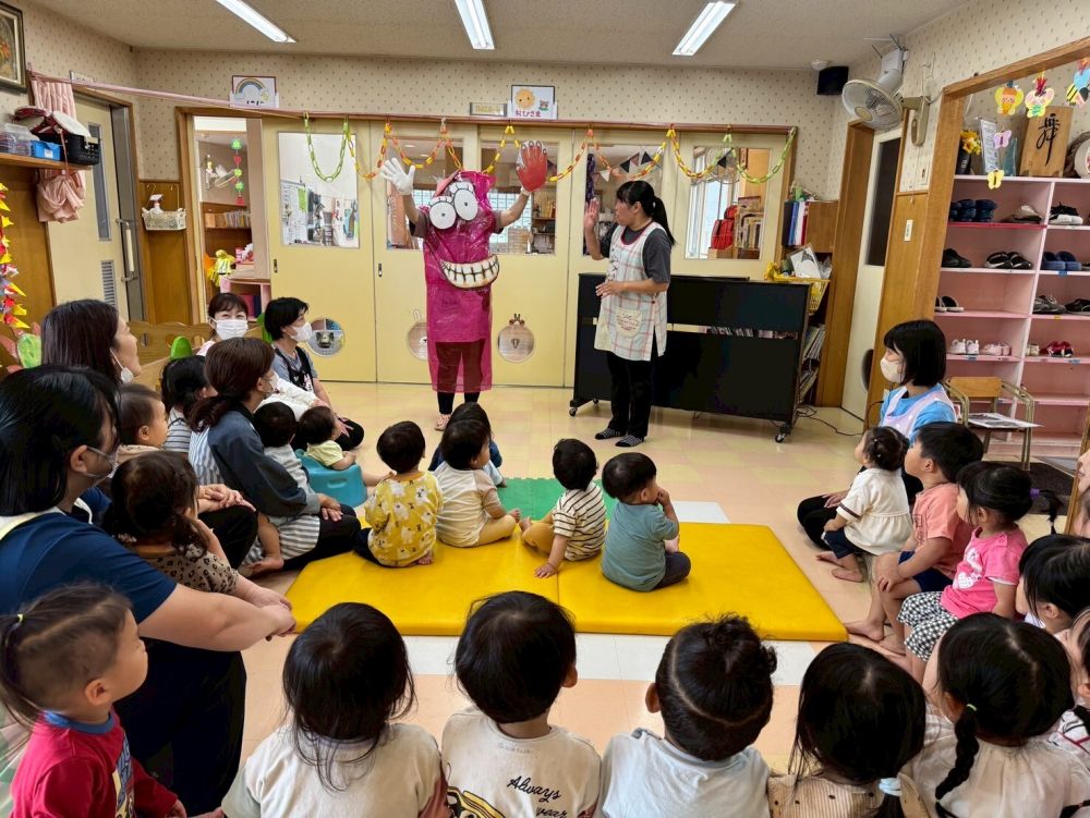 今月の先生の出し物は「だるまさん」の絵本！
絵本を読もうとすると・・・あれあれ？
だるまさんが飛び出してきちゃった！？
「だ～る～ま～さ～んの！」
からだをゆらゆらゆらしてだるまさんと一緒に楽しみました。
