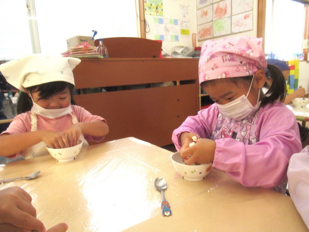 材料がなじんできたら、今度は手を使ってこねていきます。
「めっちゃこぼれた～」
「先生みたいにひとつになるん？」と、生地をまとめるのが難しそう・・・。
それでも指の力で頑張ってこねこねしていくリス組さん。
友達や先生に手伝ってもらいながら、みんなひとつの生地になりました♪