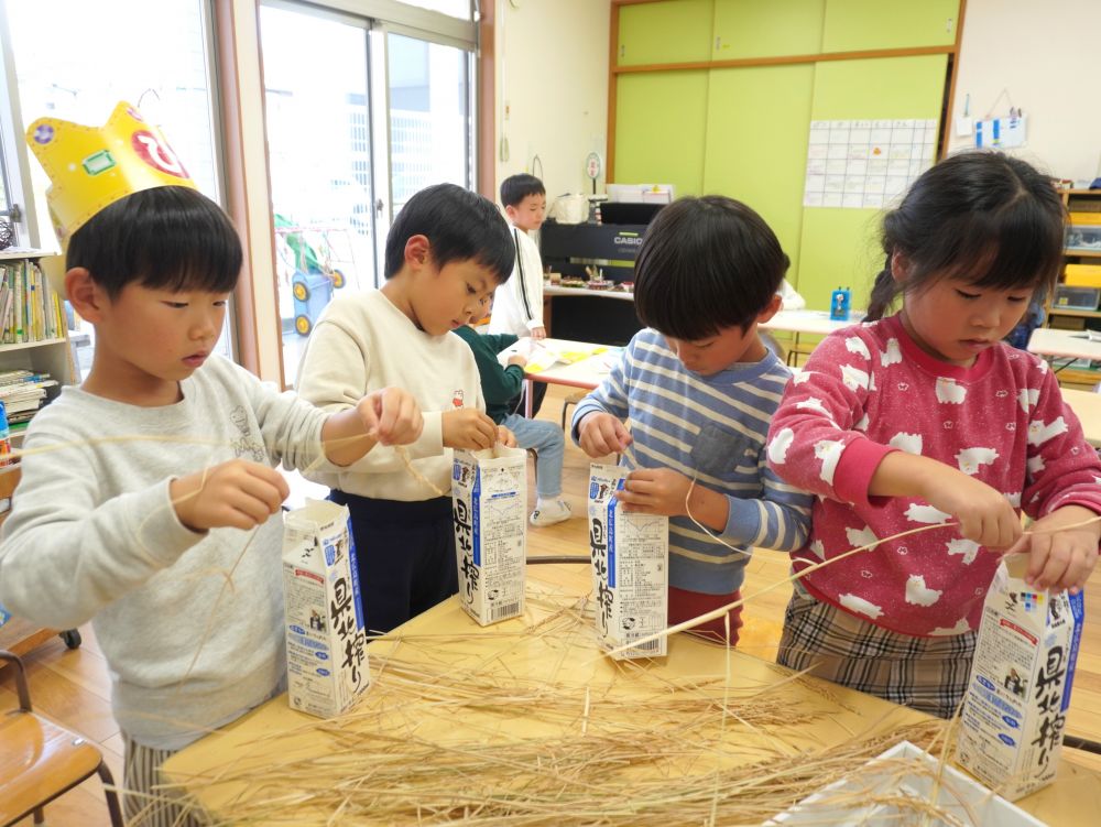 せっかくだから、自分たちのお米もさつまいもおにぎりに入れてみよう！
でも、このままでは食べられない・・・。
何をしたら良いのかな・・・？

みんなの知っている“米”になるまでに、【脱穀】と【もみすり】をしなくてはいけないと知りました！
牛乳パックを使い、【脱穀】をします。
押さえる指も、引っ張る指も、かなり力のいる作業。
うまくいくと、「パラッパラッ」と牛乳パックの中に落ちていく音が聞こえます♪