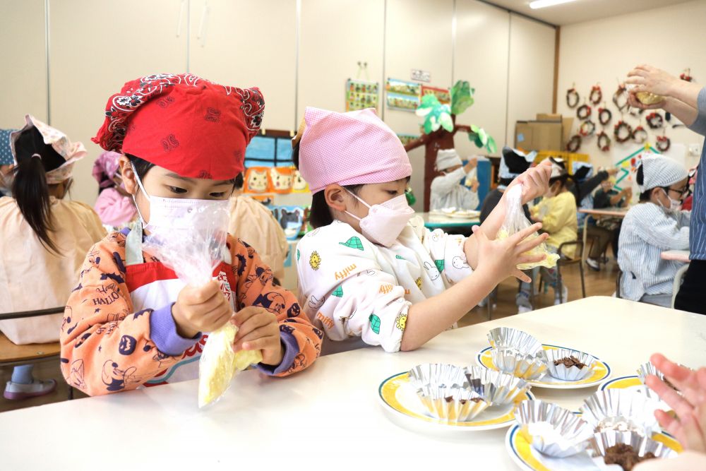 発表会の練習をしたり、園庭の畑で育てている大根を収穫したり、忙しく過ごす師走の今日
みんな大好きクッキング☆
メニューは「さつまいもｄe松ぼっくり」

茹でたお芋をモミモミしてつぶしていきます