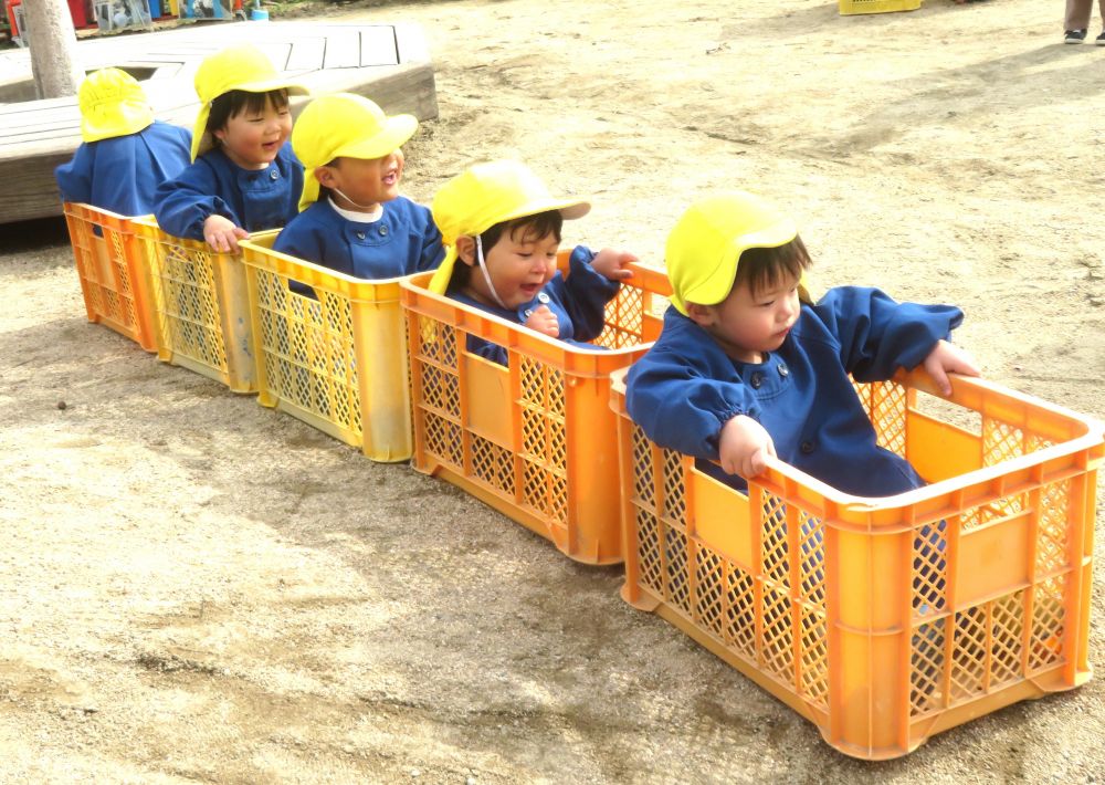 散歩から帰ってお弁当の時間まで第三園庭で遊びました
コンテナをつなげお弁当バスごっこ♪
1台だったバスがどんどん繋がり長いバスになりました
「電車みたい！」
Ⅿくんの一言にバスから電車に早変わり！
この後もどんどん電車は長くなりました
