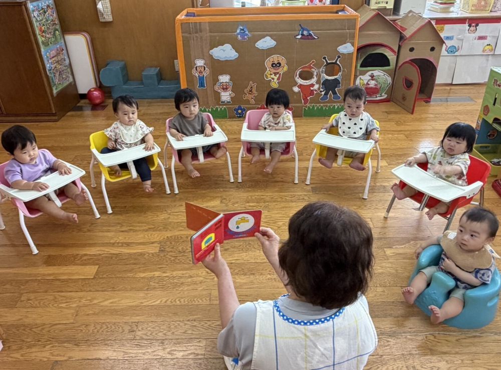 0歳児
　　『じゃあじゃあ　びりびり』

じゃあじゃあ　びりびりって何の音かな～？
正解は水道の蛇口から流れている音と
紙を破いている音です。
生活の中にある身近な物や動物が登場してきます。
色々な音があふれていますよ。
どんな擬音語が聞こえてくるか
目をきらきら輝かせて興味津々見ています。